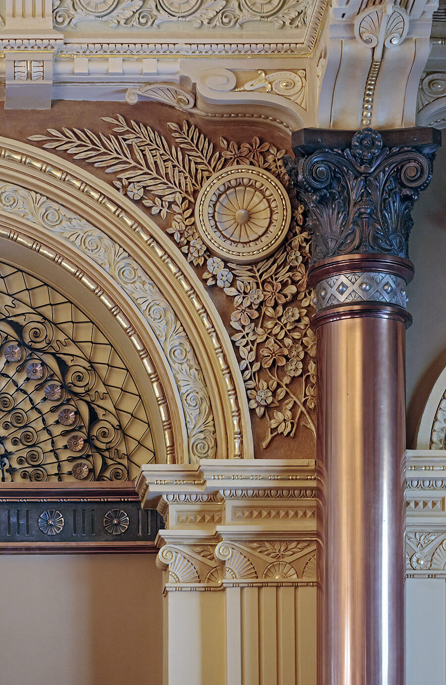 Picture of historic historic features including a copper column and decorative plaster.