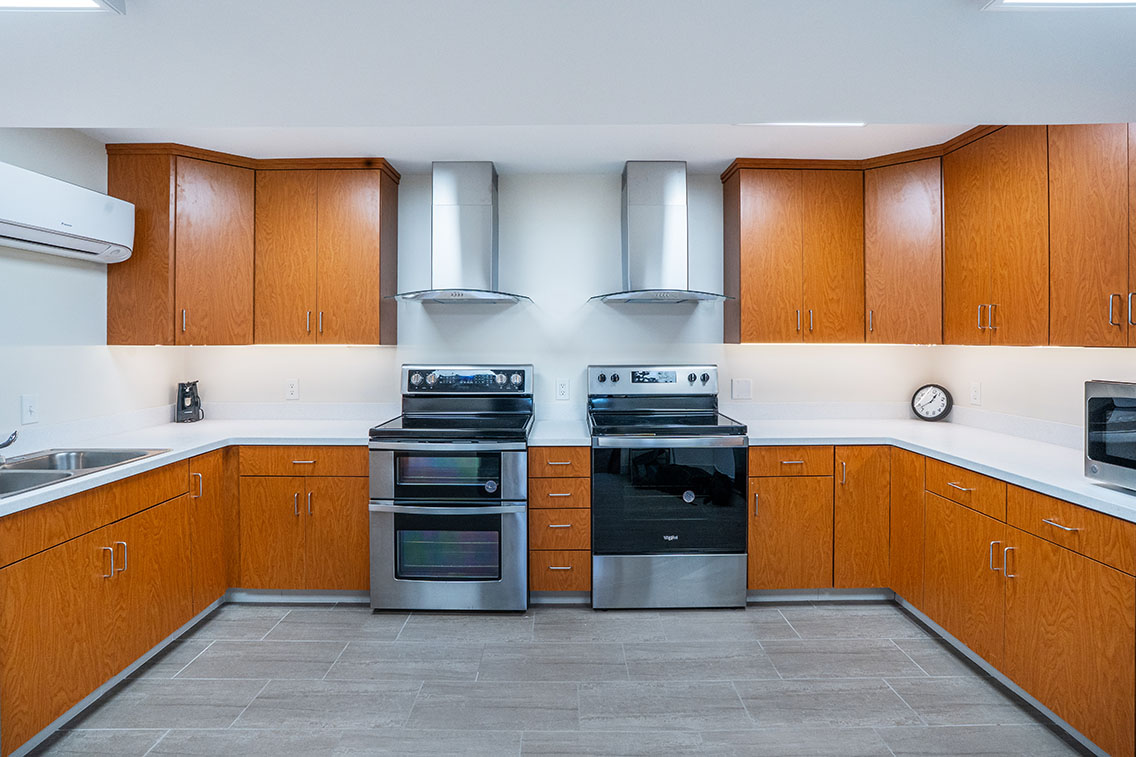 Photo of church kitchen with new appliances, flooring, and cabinetry.