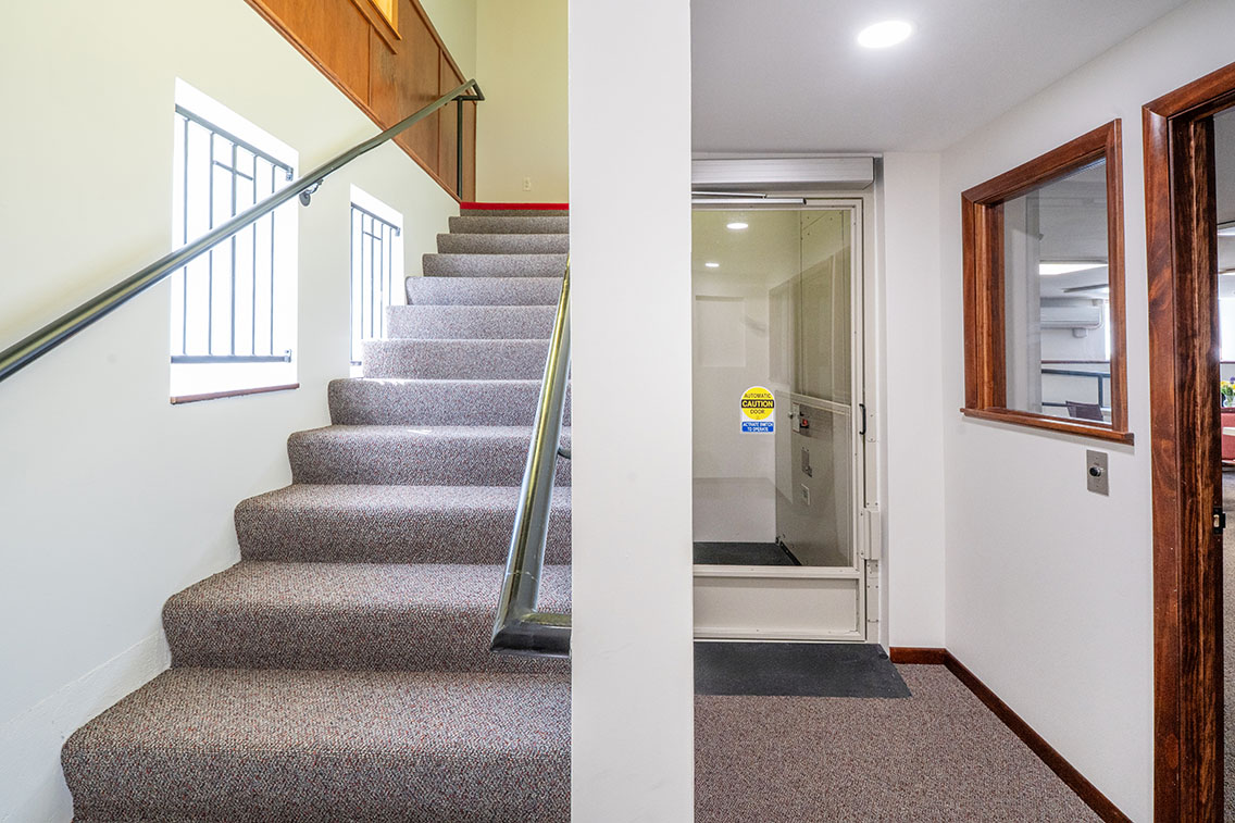 Photo featuring a church's new stair and vertical lift after replacement.