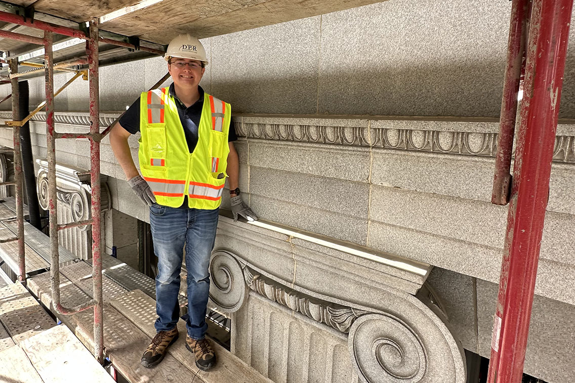 James Bibens standing on scaffolding at the Jesse Unruh State Office Building in Sacramento, California.