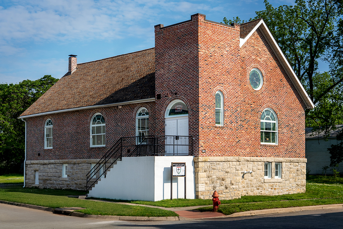 A photo of the exterior of a brick and stone church after it is rehabilitated.
