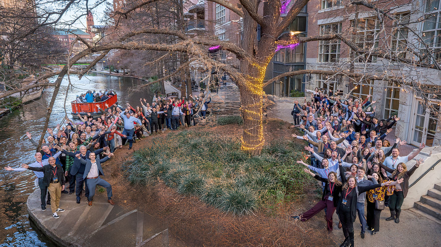 A photo of all employees of Treanor at a company event at the San Antonio Riverwalk in Texas