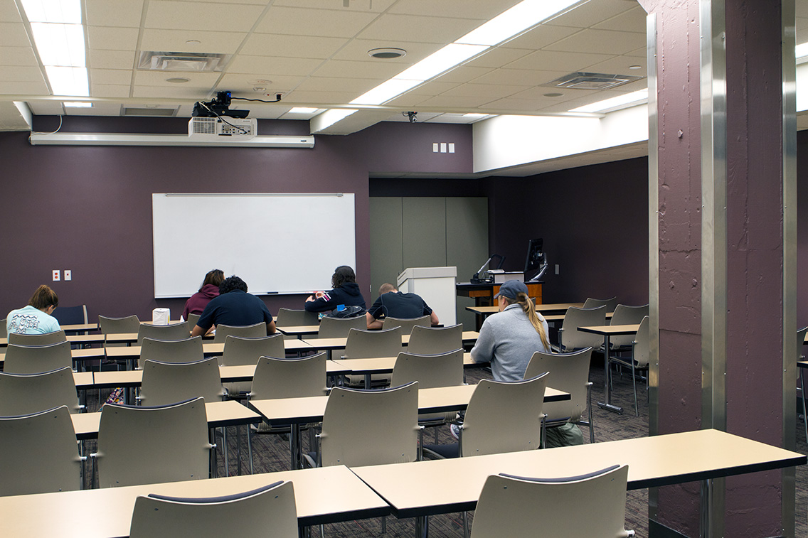 Students in a modern classroom inside the rehabilitated YMCA Building at Texas A&M