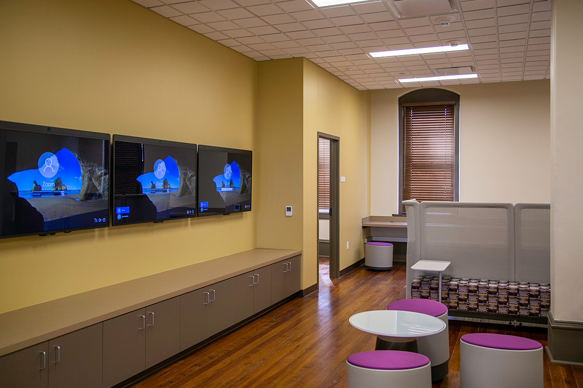 Modern office space in Nagle Hall with restored wood floors, collaborative seating, and integrated technology.