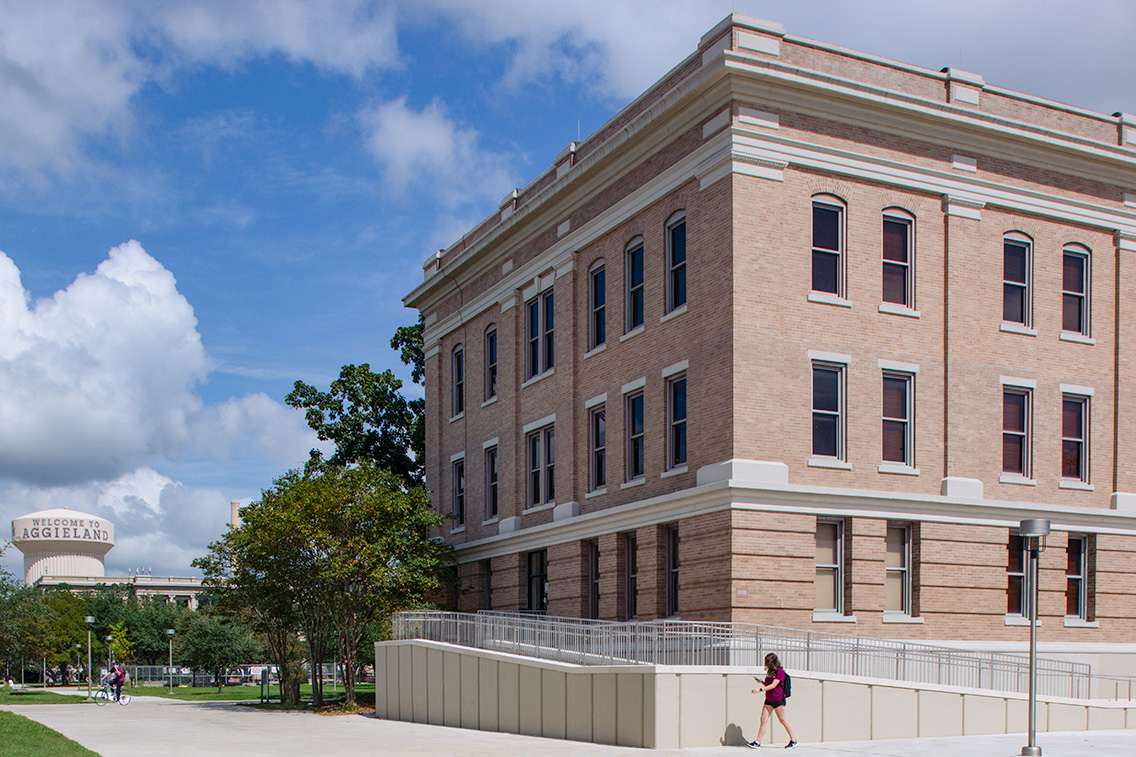 Nagle Hall exterior with new accessible ramp integrated into restored Classical Revival façade at Texas A&M.