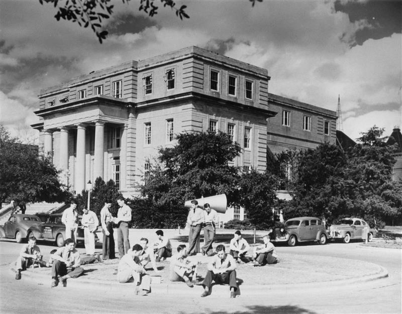 Historic YMCA Building at Texas A&M University with people gathered in front.