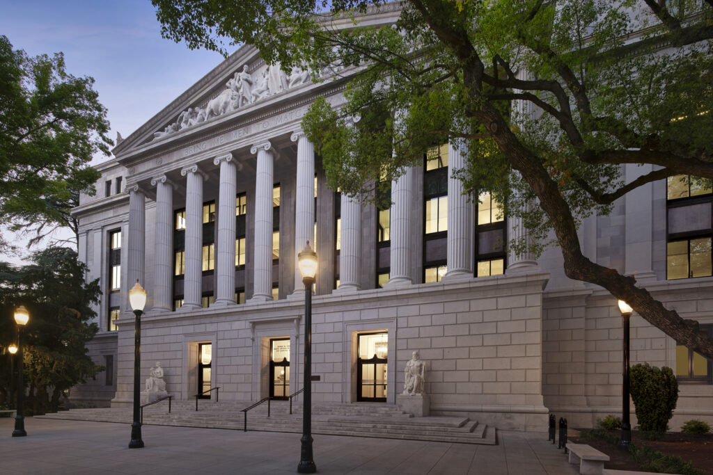 Angled view of the Jesse Unruh State Office Building in Sacramento after historic rehabilitation, showing classical columns and entryways.
